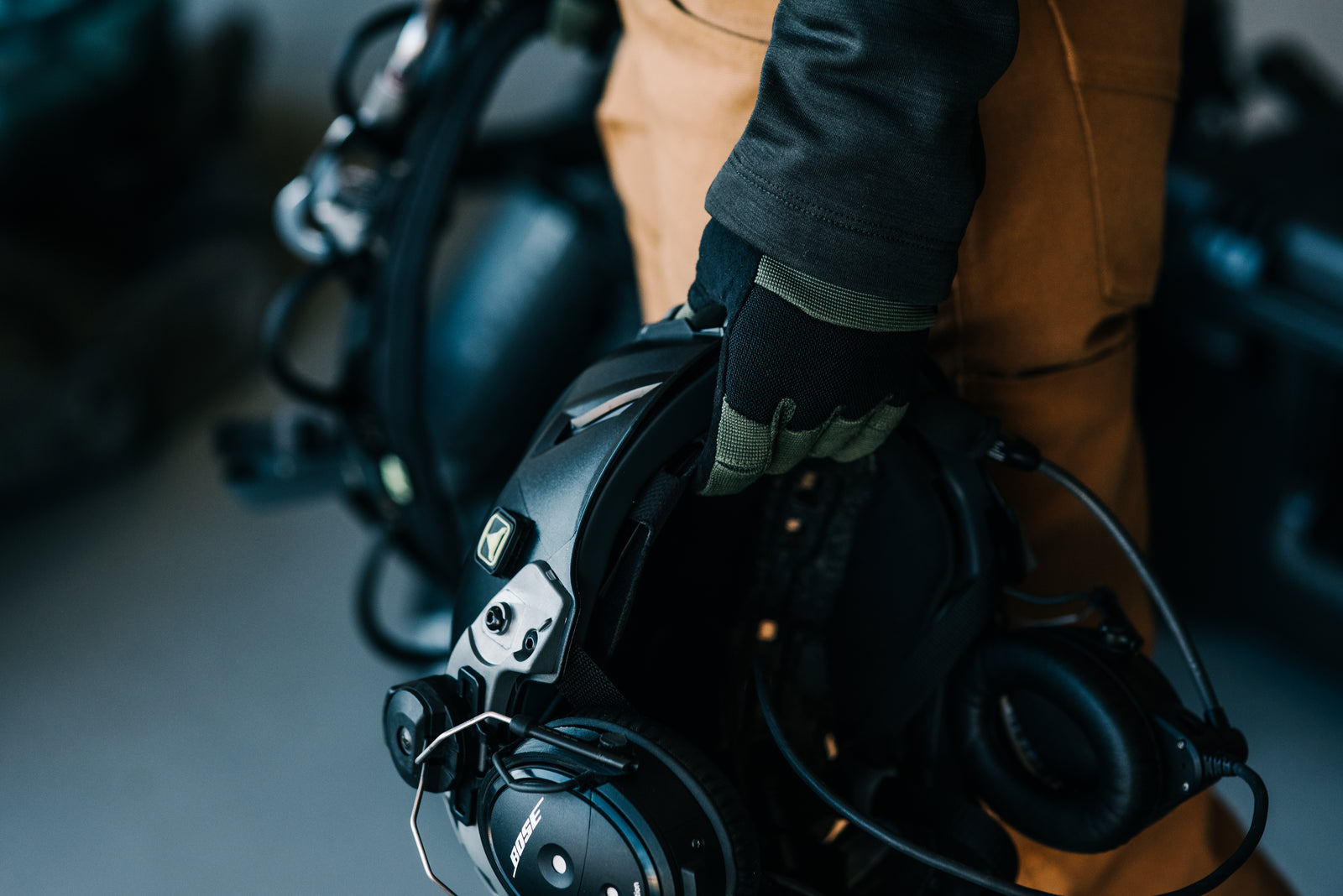 Pilot carrying a Bose A20 aviation headset out to the aircraft