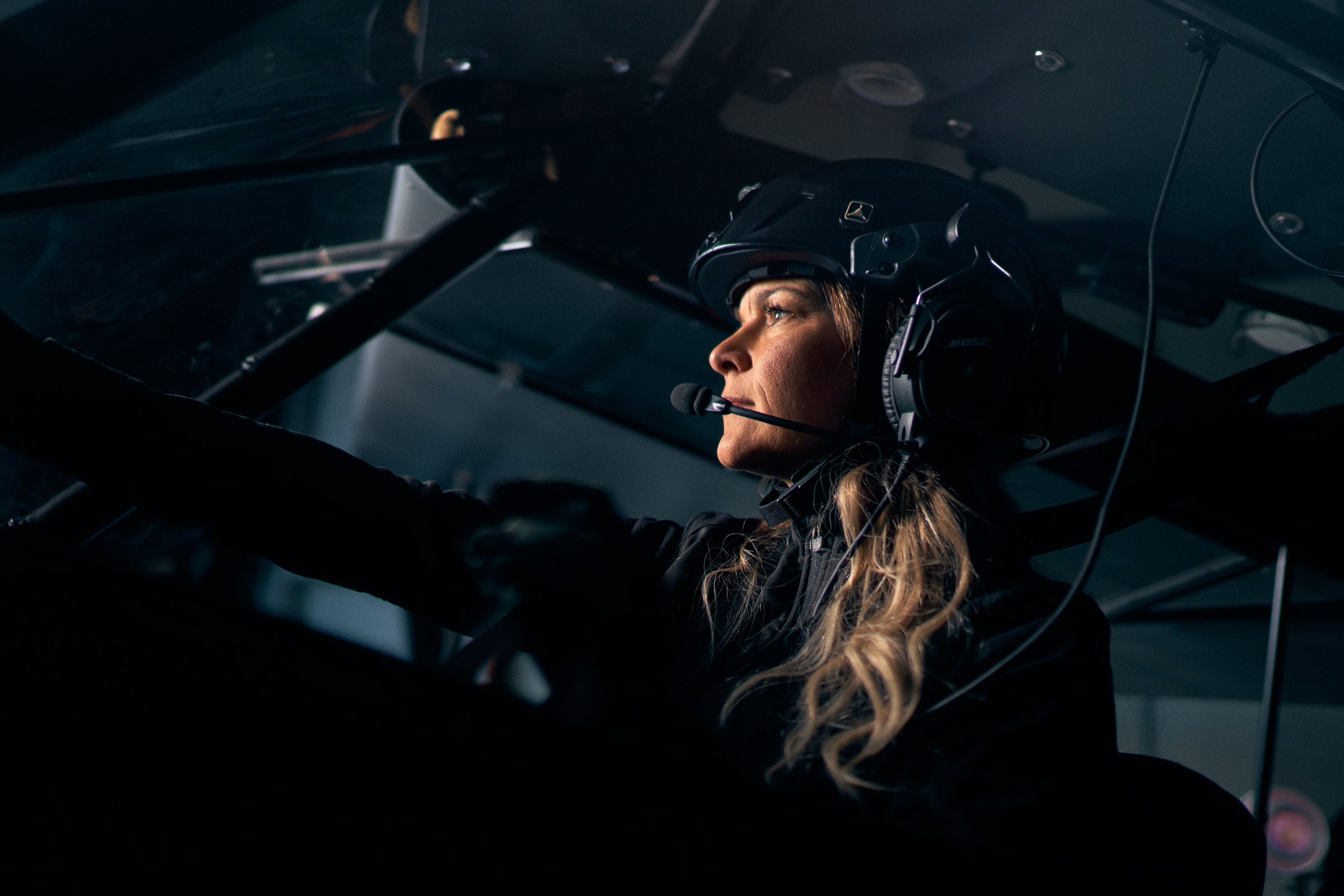 Pilot in the cockpit wearing a Sky Cowboy helmet