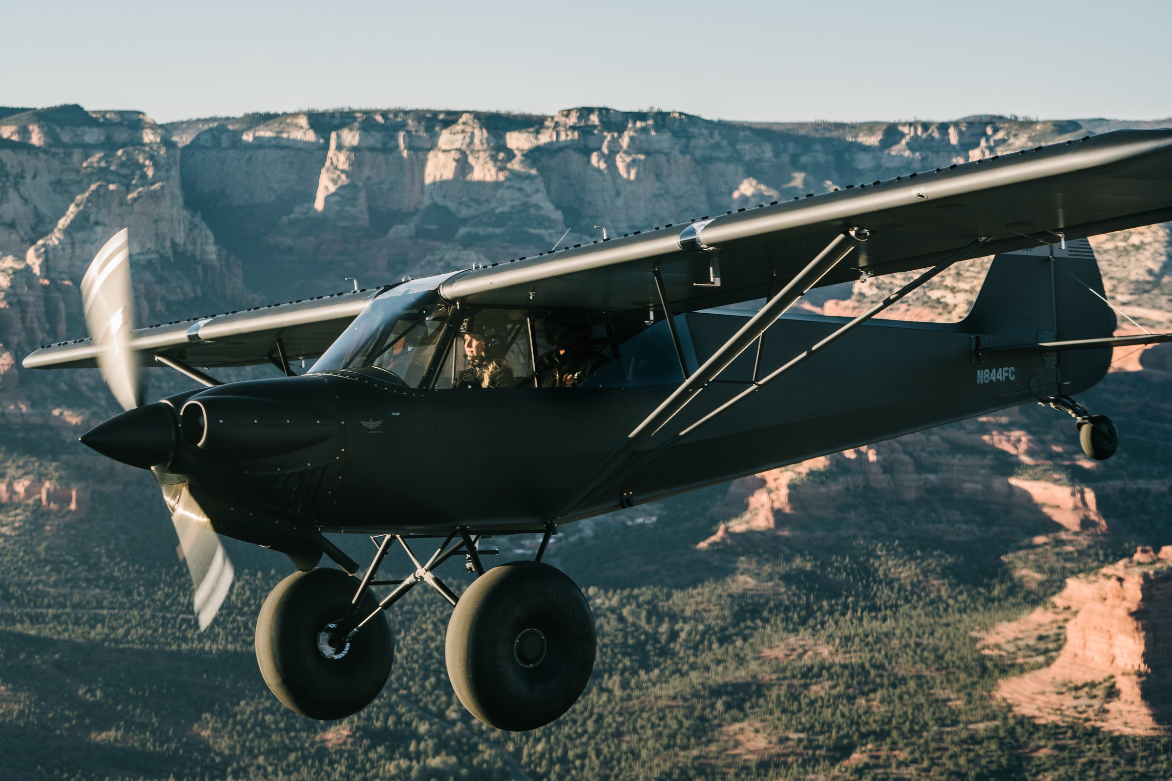 Backcountry cub flying low over red rock canyon country